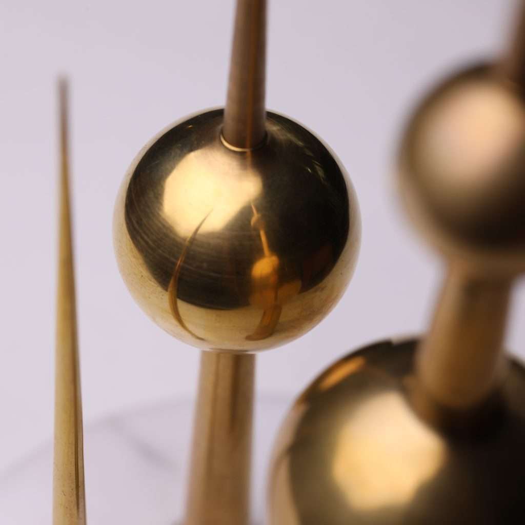 A gleaming, mirror-polished sphere on a Turath Towers replica, reflecting the surrounding environment and capturing the essence of the iconic landmark.