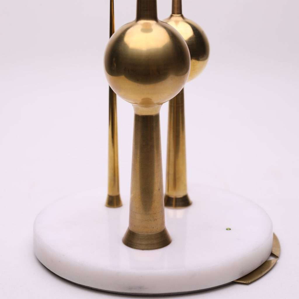 Beautifully shaped brass replicas of the Kuwait Towers, standing tall on a white marble base, symbolizing heritage and connection. Meaningful Gifting
